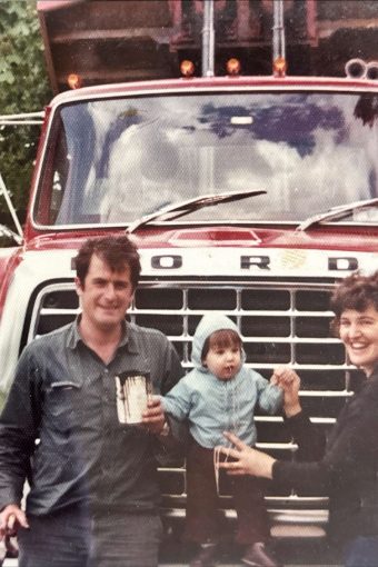 Early Toneguzzo & Son trucking family photo in front of classic Ford dump truck in Sarnia Ontario